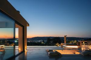 a villa with a view of the city at dusk at Inspiration House in Souda