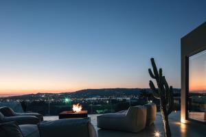 a living room with couches and a fire pit at Inspiration House in Souda