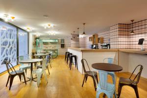 a restaurant with tables and chairs and a counter at Hard Rock Hotel Ibiza in Playa d'en Bossa