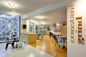 a restaurant with tables and chairs and a counter at Hard Rock Hotel Ibiza in Playa d'en Bossa