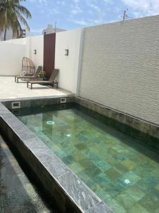a swimming pool in the backyard of a house at Eden Home Point E Studio Neuf in Dakar