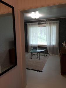 a living room with a table in front of a window at Simola in Pihtipuoas