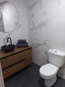 a white bathroom with a toilet and a sink at Piso exclusivo en Getafe centro in Getafe