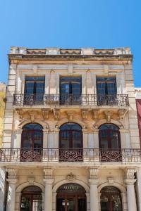 a building with a balcony on top of it at Privilege Apartment Aliança da Silva in the heart of Faro in Faro