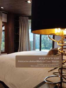 een slaapkamer met een bed en een tafel met een lamp bij Casa Albarari Boutique Double Rooms with access to shared Infinity Pool in Sanxenxo