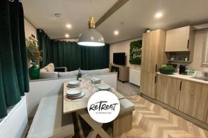 a kitchen and living room with a table and a couch at ReTreat Breaks - 45 Park Lane in Patrington +30 photos
