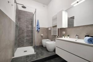 a bathroom with a shower and a toilet and a sink at The Temple of Speed & S. Gerardo Hospital in Biassono