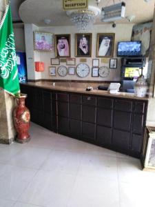 a restaurant with a counter with clocks on the wall at Al Tawfik Plaza in Makkah +19 photos