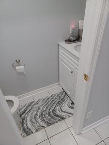 a bathroom with a toilet and a sink at Ajax Holiday in Ajax