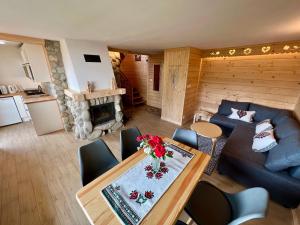a living room with a table and a couch at Domek Olczyski in Zakopane
