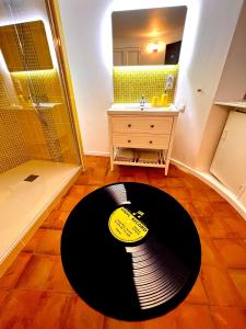 ein Bad mit einem schwarzen und gelben Teppich auf dem Boden in der Unterkunft Le Yellow - Hôtel Particulier XIXème in Montpellier