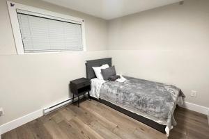 a white bedroom with a bed and a window at Luxurious Townhouse in Dieppe in Dieppe