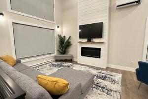 a living room with a couch and a flat screen tv at Luxurious Townhouse in Dieppe in Dieppe