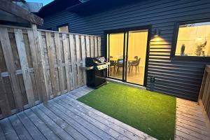 a patio with a fence and a table with a green rug at Luxurious Townhouse in Dieppe in Dieppe