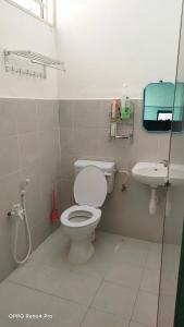 a bathroom with a toilet and a sink at Homestay Indera kayangan in Kangar