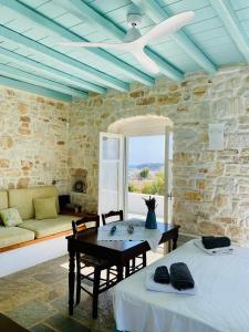 a living room with two beds and a table at Santa Maria Traditional Stone Studio in Santa Marina