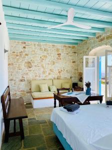 a living room with two beds and a couch at Santa Maria Traditional Stone Studio in Santa Marina