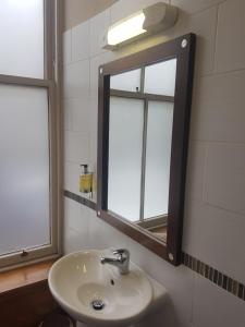 a bathroom with a sink and a mirror at Aberdeen House in Aberdeen