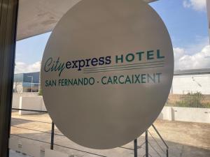 un panneau indiquant l'hôtel City Express devant un bâtiment dans l'établissement Cityexpress Hotel San Fernando - Carcaixent, 