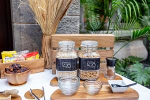 a table with three jars of seeds and a bowl of food at Suites 1478 in Las Palmas de Gran Canaria