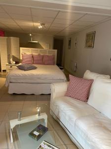 a living room with two beds and a couch at Rose Garden Studio in Giverny