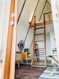 a room with a loft bed and a desk at PukuPods - Tent & Cabin in Tabanan