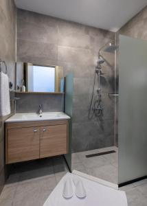 a bathroom with a sink and a shower at Sun Pearl Resort Çeşme in İzmir