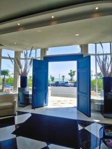 a blue door in a lobby with a view of a street at The Chatsworth Hotel in Eastbourne