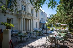 a patio with tables and chairs in front of a building at Le Champlain in La Rochelle
