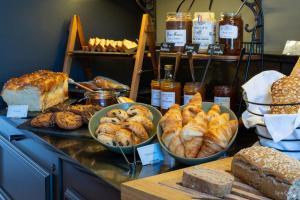 uma padaria com vários tipos de pão e pastelarias num balcão em Le Champlain em La Rochelle