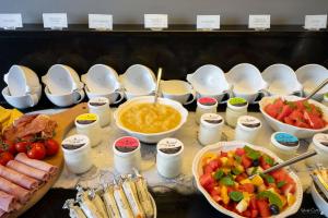 a table with bowls of food and bowls of fruit at Le Champlain in La Rochelle