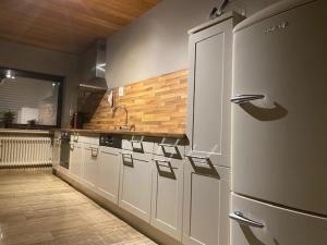 a kitchen with white cabinets and a counter top at Diemelquelle in Stryck
