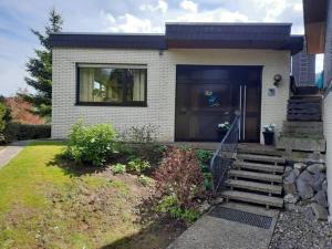 a house with a front door and stairs to it at Diemelquelle in Stryck