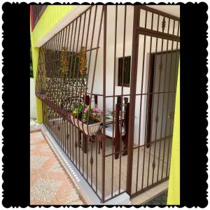 a bird cage with a table and plants in it at Apartment city center and cable car in San Felipe de Puerto Plata