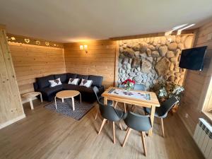 a living room with a couch and a table at Domek Olczyski in Zakopane