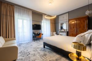 a bedroom with a large bed and a living room at Le Champlain in La Rochelle