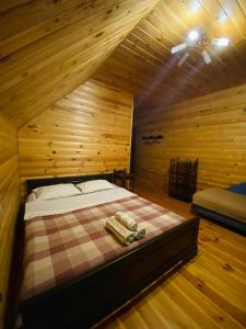 a bedroom with a bed in a wooden room at Садиба Орисин Явір Orysyn Yavir in Svityazʼ