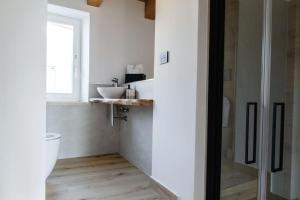 a bathroom with a toilet and a sink at Tana a 5 STELLE in Capradosso