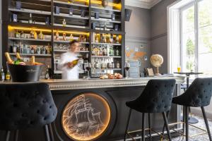 a bar with a man standing behind a counter at Le Champlain in La Rochelle