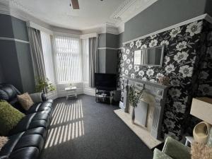 a living room with a couch and a fireplace at No 33 Central Blackpool in Blackpool