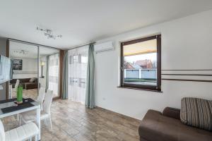 a living room with a couch and a table at Art Apartments in Hajdúszoboszló