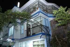 a white and blue house with a balcony at AESTHETICS - THE HOME STAY in Shillong