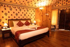 a bedroom with a large bed in a room at Om Vilas Benares in Varanasi