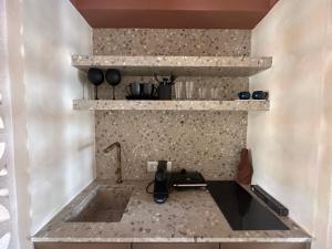 a kitchen with a stone counter with a sink at Igisó in Ermoupoli