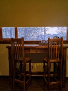 two chairs sitting at a desk in front of a window at LengaUsh in Ushuaia