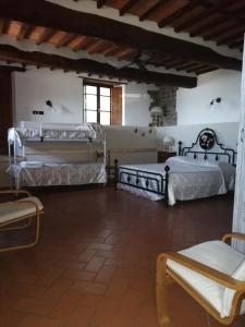 a large room with two beds in a building at Affittacamere Adri in Uzzano