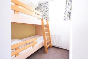 a bunk bed room with two bunk beds and a ladder at Grajski Dvor in Radovljica