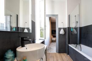 a bathroom with a sink and a shower at Le Champlain in La Rochelle