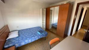 a small bedroom with a bed and a mirror at flat Holiday friend group or family near beach center blasco ibanez in Valencia