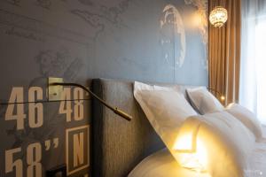 a bedroom with a bed and a clock on the wall at Le Champlain in La Rochelle